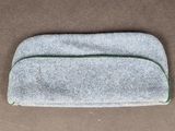 a close up of a small gray bag on a brown surface
