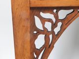 a wooden shelf with a clock on top of it