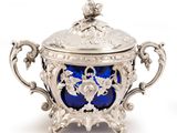 an antique silver and blue glass covered bowl on a stand