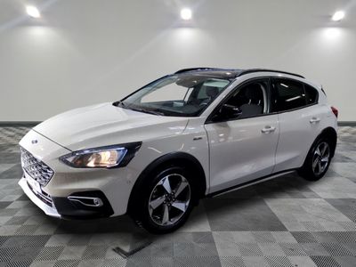 the white car is parked on a checkered floor in the garage