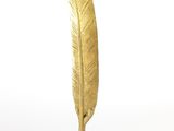 gold feather pen on a white background