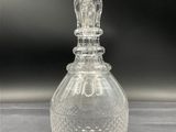 an image of a clear glass decanter on a table