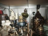 many different types of vases and lamps on the shelf
