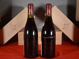 two bottles of wine sitting next to each other on a table