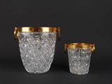 a pair of cut glass ice buckets with gold rims