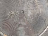 a close up of a metal plate with a design on it