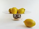 a glass plate with a bunch of lemons on it