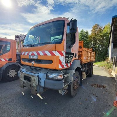two orange trucks parked next to each other in a parking lot