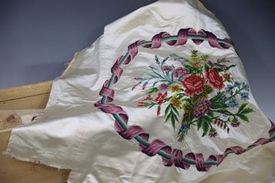 a white pillow with a floral design on it