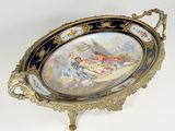 a decorative tray with a painting on it on a stand