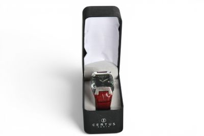 a watch in a black box with a red strap