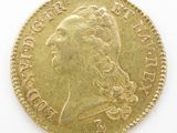 a close up of a gold coin on a white surface