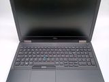the dell laptop is open and ready to be used on the desk
