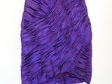 a purple dress with a green top on a hanger
