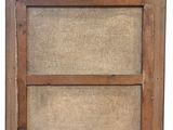 an old wooden window frame with a burlock cloth covering it
