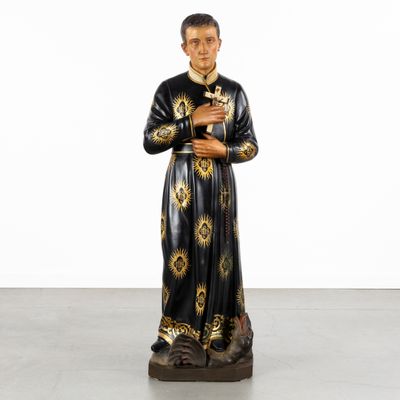 an image of a statue of a man holding a rosary