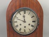 une petite horloge en bois avec des chiffres romains