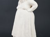 an image of a statue of a woman in a white dress