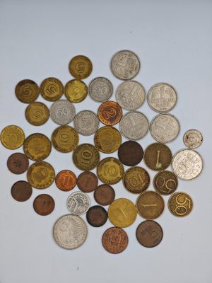a pile of coins on a table with a white background