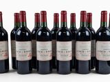 six bottles of red wine lined up in a row on a white surface