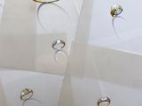 many different types of rings on display in a display case