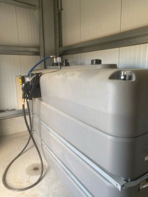 a tank with a hose attached to it in a garage