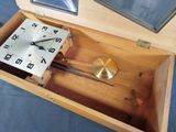 a wooden box with a clock inside of it