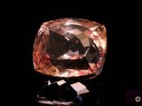 an image of a pink diamond on a black surface