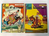 two comics are sitting on a table with a white background