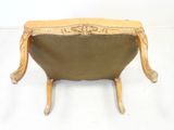 a small wooden bench with a leather seat on it