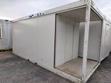 an image of a couple of white shipping containers sitting in a parking lot