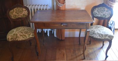 a small table and two chairs in a room