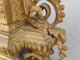 a gold clock sitting on top of a table