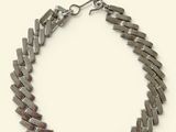 bracelet made of silver metal strips with a clasp on a white background