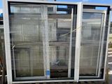 two windows that are on a pallet in front of a building