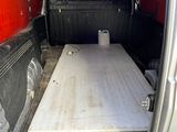a bed in the back of a van with a mattress in it