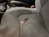 a car seat with a sticker on it and a remote control