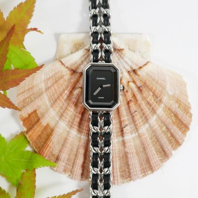 black and silver watch on a black and white chain bracelet