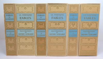 four books are lined up in a row on a white surface