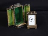 a small clock inside of a green case on a black background