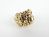 a close up of a gold ring on a white surface