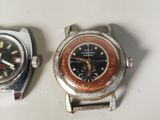 two watches sitting next to each other on a table