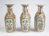 three vases sitting side by side on a white surface