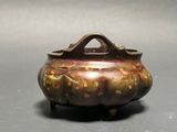 a small metal pot with a handle on a table