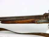 an old gun that is on display on a white surface
