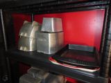 many pans and pans sitting on a shelf in a kitchen