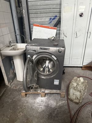 une machine à laver et un lavabo dans une pièce sale