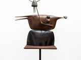 sculpture of a cat sitting on top of a pot on top of a wooden stand