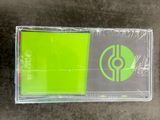 a green sticker on the floor next to a black and white picture