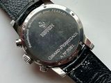 a close up of a watch on a white surface
